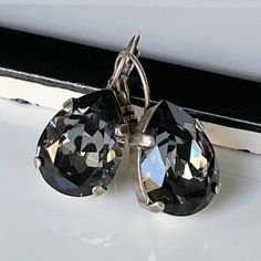 "These gorgeous earrings display dazzling crystal silver shade teardrops. The Swarovski crystals are set in sterling silver-plated bezels and hang from silver lever back earrings.  Perfect for that special occasion! * Swarovski Crystal Teardrops- 1/2x3/4\"(13x18mm) * Antique Silver-Plated Bezels and Earrings * Length- 1 1/4\"(31mm) * Nickel Free These earrings come in a jewelry bag and gift box." Silver Teardrop Crystal Earrings, Silver Crystal Dangle Teardrop Earrings, Silver Crystal Teardrop Dangle Earrings, Silver Pear-shaped Crystal Earrings For Party, Faceted Crystal Teardrop Earrings, Nickel Free Pear-shaped Silver Earrings, Silver Crystal Earrings With Lever Back For Formal Occasions, Classic Silver Hypoallergenic Crystal Earrings, Silver Crystal Teardrop Earrings For Anniversary