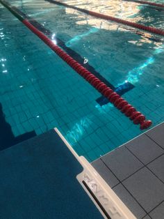 an empty swimming pool with no people or swimmers in it and blue tiles on the floor