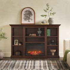 a living room with a fire place in the center and a rug on the floor