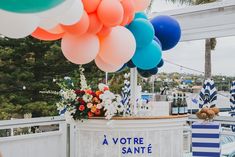 there is a bar with balloons on the top and flowers at the bottom that says la votre sante