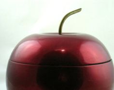 an apple shaped container sitting on top of a table