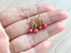 These dainty and cute cherry earrings are made of the following: (1) Gold plated red and green enamel cherry charm (12 x 10mm) (2) Gold plated or 14KGF earring hooks ✏️ Please choose your desired earring hooks 🍒EARRINGS 🍒 Clip On Hoops → https://www.etsy.com/listing/905698702 Threader -> https://www.etsy.com/listing/602107194 🍒NECKLACE 🍒 -> https://www.etsy.com/listing/615948435 【ADDITIONAL QUANTITY】 Kindly convo us if you require additional quantity and we will be happy to customize t Cute Cherry-colored Jewelry For Gifts, Cute Cherry-colored Jewelry Gift, Sweet Red Earrings For Gift, Nickel Free Cherry Colored Earrings For Gift, Cherry Colored Earrings For Valentine's Day Gift, Nickel Free Cherry Earrings For Gift, Cherry Color Earrings For Valentine's Day Gift, Nickel-free Cherry Colored Earrings For Gift, Cherry Earrings For Valentine's Day Gift