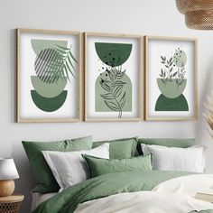 three framed art prints on the wall above a bed with green sheets and pillows in a bedroom