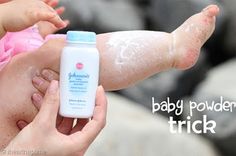 a person holding a baby in their arms with some soap on it's arm