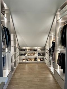 a walk in closet filled with lots of shoes and clothing on shelves next to each other