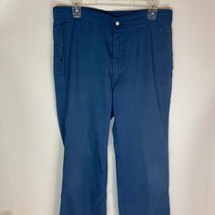 "Levi pants (not denim) in good vintage condition. Made \"with a skosh more room\". Featuring metal snaps and thick quality cotton material. Size 34/34" Cotton Bottoms With Button Closure And Flat Front, Vintage Dark Wash Pants With Pockets, Retro Washed Blue Straight Leg Bottoms, Vintage Cotton Bottoms In Medium Wash, Retro Style Denim Blue Cotton Pants, Washed Blue Cotton Pants, Vintage Cotton Bottoms In Dark Wash, Vintage Denim Blue Cotton Pants, Vintage Medium Wash Cotton Bottoms