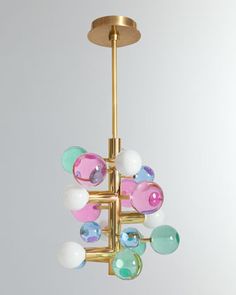 a chandelier hanging from the ceiling with colorful beads on it's sides