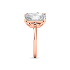 a rose gold ring with an oval cut diamond in the center