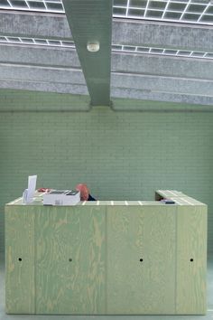 a man sitting at a desk in an empty room