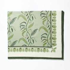 a green and white placemat with leaves on it