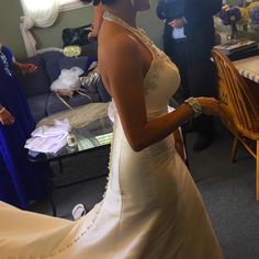 a woman in a wedding dress standing next to a table