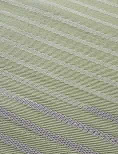 a green and white striped area rug