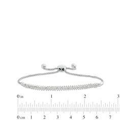 Make a brilliant statement with this diamond double row diagonal line bolo bracelet. 10K white gold. Wheat chain bolo is centered with a double row of diamonds set on the diagonal. 3/8 ct. t.w. of diamonds. 9.5-inch bracelet; adjustable bolo clasp. Anniversary Diamond Bracelet With Adjustable Chain, Fine Jewelry Diamond Bracelet With Adjustable Chain For Anniversary, Adjustable Diamond Cut Tennis Bracelet In Fine Jewelry Style, Adjustable Sterling Silver Diamond Bracelet With Prong Setting, Fine Jewelry Adjustable Tennis Bracelet With Diamond Cut, Adjustable Silver Diamond Bracelet With Prong Setting, Fine Jewelry Tennis Bracelet With Diamond Cut, Adjustable White Gold Tennis Bracelet, Silver Tennis Bracelet With Adjustable Chain For Formal Occasions