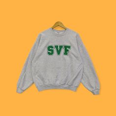 "Vintage SVF sweatshirt SVF crewneck SVF sweater pullover spell out streetwear green letter grey colour size x-large  Brand Name :- SVF 📌 Tag Size :- Fit x-large Manual Measurement :- WIDTH (armpit to armpit) :- 24\" inches  LENGTH (shoulder to end of garment) :- 26\" inches  SLEEVE (shoulder to end of sleeve) :- 23\" inches  Condition :- Good Condition 8/10. Minor Defect  Refer Picture. 📮 Shipping = 7-10 business day arrived 🔥SALE SALE SALE🔥" Oversized Gray Varsity Sweatshirt, Heather Grey Letter Print Sweater For Streetwear, Heather Grey Sweater With Letter Print For Streetwear, Heather Grey Crew Sweater For Streetwear, Heather Grey Crew Neck Sweater For Streetwear, Winter Streetwear Sweater With Lettering, Heather Grey Crew Sweatshirt, Green Long Sleeve Sweatshirt With Lettering, Crew Sweater With Lettering For Streetwear