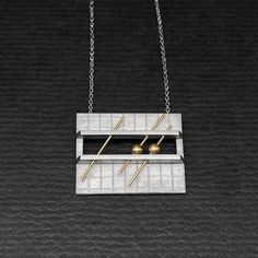 OVERVIEW:  Here's a vintage c1980s studio made sterling necklace.  The pendant is rectangular with a hand-engraved grid pattern.  At the center are two applied bands holding 3 14K gold wires, two of which have 14K beads.  Design has a very cool mathematical/graph-like character!  Pendant is attached to a fine curb link chain with a spring clasp.  This piece is not signed but it comes from a good NYC collection of modernist & contemporary artist jewelry. MARKS:  none, tested and guaranteed sterling & 14K DIMENSIONS: pendant is 1" x 7/8"; wearable length 18" WEIGHT:  7.04g CONDITION:  excellent Modern Etched Gold Jewelry, Modern Silver Rectangular Necklaces, Modern Necklace With Rectangular Pendant And Box Chain, Modern Jewelry With Large Rectangular Pendant, Modern Formal Necklace With Rectangular Pendant, Modern Necklace With Rectangular Box Chain, Modern Rectangular Box Chain Necklaces, Modern Metal Necklace With Rectangular Pendant, Modern Sterling Silver Etched Jewelry