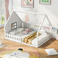 a child's bedroom with a doll house bed, rug and pictures on the wall