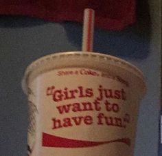 a paper cup with a straw in it that says girls just want to have fun