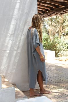 Style // The ultimate stormy blue kaftan is perfect for any occasion When comfort meets style, the Cala Kaftan features a billowy, shapeless silhouette and mid-length. With a v-neck silhouette, wide sleeves and two side slits, it promises to be your go-to look for that cozy, effortless look. The lightweight linen-cotton blend fabric is extra soft, to ensure you won't ever want to take it off Fabric Note // Made in Italy from a Linen & Cotton blend Sizing Advice // Available in one size, for an o Casual V-neck Kaftan For Daywear, Blue Relaxed Fit V-neck Tunic, Casual V-neck Relaxed Fit Kaftan, V-neck Tunic For Daywear With Relaxed Fit, Relaxed Fit V-neck Tunic For Daywear, Blue V-neck Kaftan For Loungewear, Relaxed Fit V-neck Tunic For Loungewear, Oversized Blue Casual Kaftan, Blue Oversized Kaftan For Loungewear