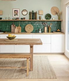 a wooden table sitting in the middle of a kitchen