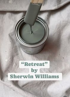 a paint can with a brush in it and the words, retreat by sherwin williams