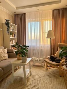 a living room filled with furniture and a cat laying on top of a coffee table