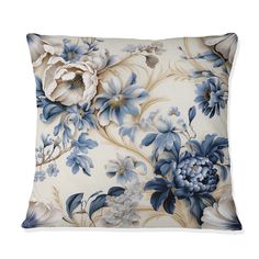 a blue and white flowered pillow on a white background, with large flowers all over it