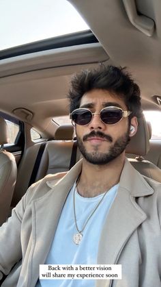 a man wearing sunglasses sitting in the back seat of a car with a quote written on it