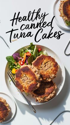 healthy tuna cakes on a white plate with salad and fork next to the plate are two plates