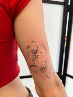 a woman with a flower tattoo on her arm