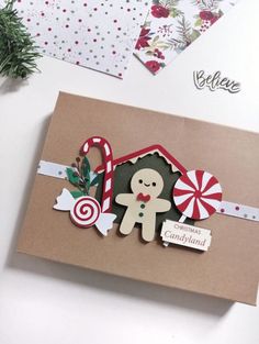 a christmas card with a gingerbread man and candy canes on the front, surrounded by other holiday cards