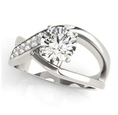 This brightly polished engagement ring features a sparkling round brilliant cut high-quality Neo moissanite prong-set in the center. A stunning asymmetrical setting is fashioned into the classic hugs and kisses XOXO shape, giving this ring a remarkable appearance. Glittering round brilliant cut diamond side stones are set on one side of the band, adding a glamorous touch. Celebrate your engagement ring that is worth every picture with this romantic engagement ring. Perfect for those who seek something regal and radiant with an imaginative design. APPROXIMATE POLISHED DWT 4.68 STONE BREAKDOWN COMPONENTS QTY QUALITY 1-1.0ct rd. Neo Moissanite Center stone 14-Rd. E-F/VS Lab Created diamonds weighing .13ctw TOTAL WEIGHT OF DIAMONDS .13 cttw    Semi-Mount 1.13 cttw    Complete OPTIONS: The matc Modern Twist White Diamond Ring, Modern Bypass Ring For Promise With Round Cut, Modern Twist White Diamond Ring For Anniversary, Elegant Diamond White Bypass Ring With Tension Setting, Modern Twist Diamond Bypass Ring For Anniversary, Modern Twist Cubic Zirconia Diamond White Ring, Modern Twist Diamond Wedding Ring With Brilliant Cut, Modern Bypass Ring With Brilliant Cut, Modern Brilliant Cut Diamond White Bypass Ring