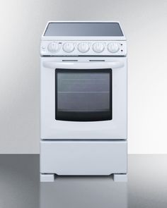 a white stove sitting on top of a counter next to a silver wall and floor