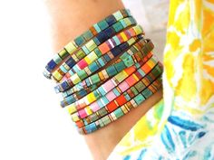 "Tila beads are a Japanese glass made in so many different colors and finishes. They make beautiful and elegant jewelry. I've made many different designs based on the color palettes in some of my most popular seed bead wrap bracelets. The little tiles lay flat on your wrist and are really comfortable. They can be worn alone, stacked or add interest to anything from a simple gold chain to a dramatic bangle. They are also very affordable and make great gifts. I show them stacked with some of my ot Modern Multicolor Beaded Bracelets As Gift, Adjustable Multicolor Friendship Bracelets With Faceted Beads, Modern Adjustable Beaded Bracelets With Tiny Beads, Modern Adjustable Multicolor Jewelry, Modern Beaded Bracelets With Spacer Beads, Multicolor Czech Glass Bracelets With Unique Variations, Modern Handmade Beaded Bracelets With Round Beads, Multicolor Polished Beads Bohemian Bracelets, Modern Handmade Beaded Bracelets