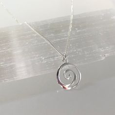 Simple and dainty swirl pendant necklace in sterling silver This necklace features a shiny sterling silver swirl pendant suspended on a dainty but sturdy sterling silver chain and finished with a lobster claw clasp. A minimalist-styled and elegant necklace suitable for any age and occasion ! Details: necklace length:  please choose at check-out  sterling silver swirl pendant: 12 mm sterling silver chain and clasp Thanks for visiting ! Back to my shop for more jewelry options: www.etsy.com/shop/k Silver Swirl Necklace, Simple Sliver Pendant, Small Silver Pendant Necklace, Minimalist Silver Spiral Necklace, Sterling Silver Swirl Necklaces, Spiral Sterling Silver Necklace In Silver, Swirl Necklace, Spiral Pendant, Vintage Jewelry Antique