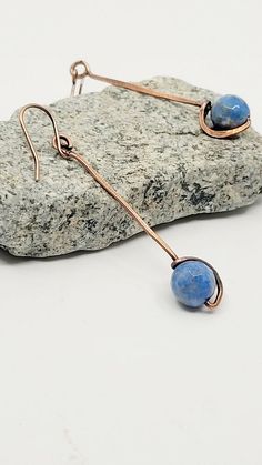 "Beautiful antiqued raw copper with 8mm blue lapis stone.  These hang approximately 2\" from top of the ear wire.  Unique and flattering. I have added a clear coating to prevent further oxidation. Care Instructions: - Remove your jewelry before showering, sleeping, swimming or sweating. - Most pieces, unless otherwise specified, can be cleaned with a mild dish soap and soft toothbrush  if really necessary. Do NOT soak your jewelry or use any chemicals. - Clean your jewelry before and after each use with a soft dry polishing cloth.  >Please keep in mind when ordering that color settings on your screen and lighting in product photography vary so the product might differ a tad from what you see on screen. I do accept returns, exchanges, and cancellations. Contact me within 14 days of delivery Blue Artisan Copper Earrings, Artisan Blue Copper Earrings, Blue Copper Wire Wrapped Earrings, Artisan Blue Hand Forged Earrings, Artisan Hand Forged Blue Earrings, Hand Forged Artisan Blue Earrings, Blue Copper Wire Earrings With Ear Wire, Blue Hand Forged Bohemian Earrings, Blue Bohemian Hand Forged Earrings