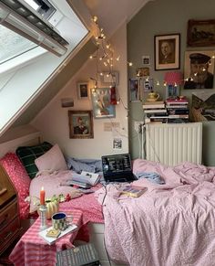 a bedroom with a bed, desk and laptop on it