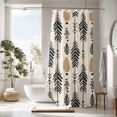 a bathroom with a bathtub, sink and shower curtain that has black and gold leaves on it