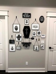 a wall with many pictures hanging on it