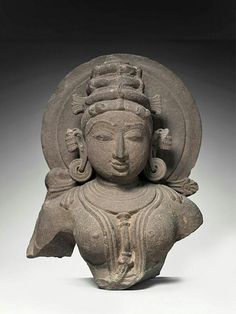 an ancient statue is shown in grey tones and features a headdress on it's face