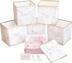 six white and pink boxes with gold trim