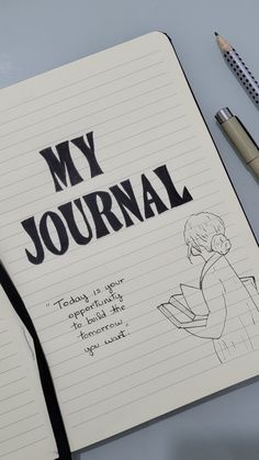 an open notebook with the words my journal written on it next to some pens and pencils