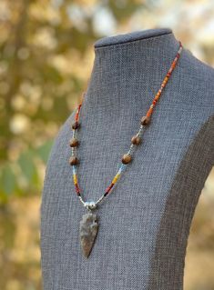 "Authentic Native American, handmade, Cedar Juniper Berry seed necklace with Natural Agate Arrowhead. Cedar beads, colorful glass seed beads (size 11/0) and round silver beads (6mm) are strung with jewelry wire and closed with lobster claw clasp. Navajo legend says Cedar beads, also known as \"Ghost Beads,\" will keep evil spirits and bad dreams away. For example, it is customary for Navajo mothers to place strung cedar beads on/near their traditional cradle boards used by their infants. By seas Spirit Energy, Seed Necklace, The Hallow, Navajo Necklace, Native American Necklace, Arrowhead Necklace, Juniper Berry, Necklace Patterns, Bad Dreams