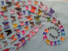 many different colored butterflies on a table