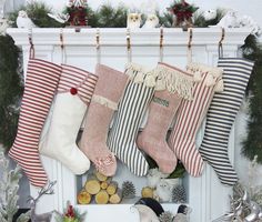 stockings hanging from a mantel decorated with christmas decorations