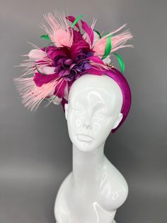 Chunky headband fascinator in magenta. Adorned with shades of purple, pink and pops of green. Attached is the jeweled bee, my signature mark. This piece is one size fits all. Please note all sales are final. Pink Mini Hats With Matching Headband For Parties, Pink Headband For Kentucky Derby Party, Pink Headband For Kentucky Derby, Pink Mini Hat With Matching Headband For Party, Elegant Multicolor Headband For Party, Purple Headband For Kentucky Derby, Pink Party Mini Hat With Matching Headband, Purple Headpieces With Matching Headband For Party, Pink Headband For Races