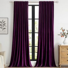 the purple curtains are hanging in front of a window