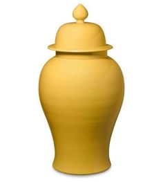 a large yellow vase with a lid on the top is sitting in front of a white background