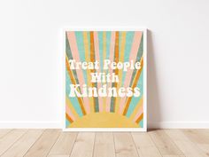 a poster with the words treat people with kindness on it in front of a white wall