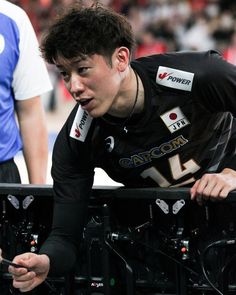 a man in black shirt leaning over a metal rail