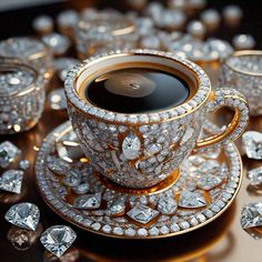 a fancy cup and saucer on a plate with some diamonds around the rims